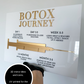 Botox journey acrylic sign in white and gold 